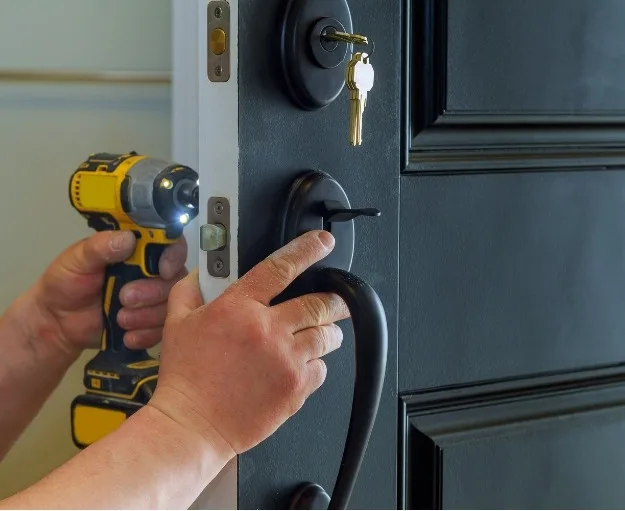 Licensed locksmith technician installing deadbolt lock on North Vancouver home